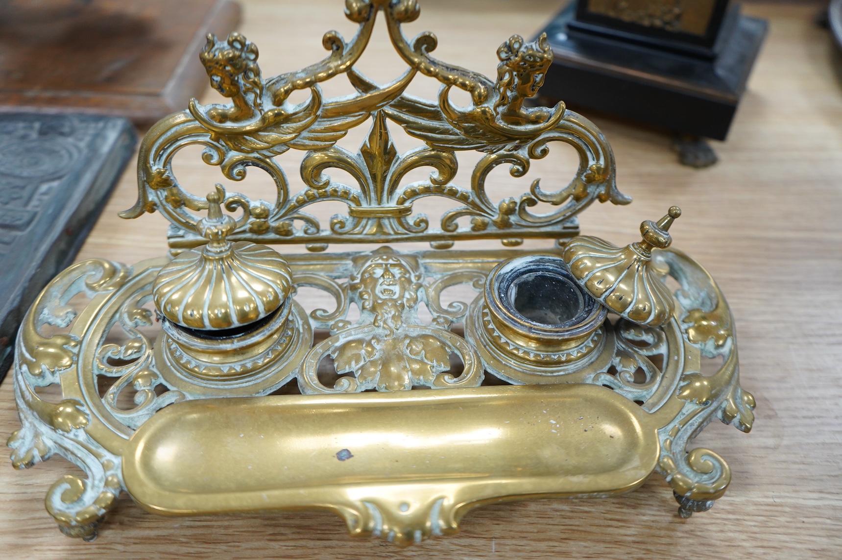 An early 20th century ormolu and marble ‘cherub’ converted candelabra and a brass desk stand, tallest 56cm
